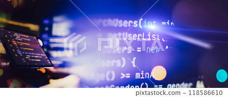 Programmer manually working with program code on a computer at night in a data center and technology concept. Programmer manually working with program code on a computer at night in a data center and technology concept. 118586610