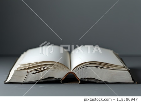 A blank white hardcover book rests on a gray background. 118586947