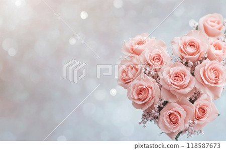 A heart-shaped arrangement of pink roses surrounded by shimmering background at a romantic event 118587673