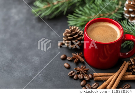 Warm red mug on a dark surface surrounded by coffee beans, cinnamon, and festive greenery Warm red mug on a dark surface surrounded by coffee beans, cinnamon, and festive greenery 118588104
