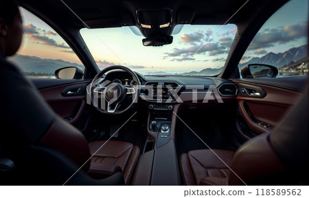A man sits in the drivers seat of a car, looking out the window 118589562