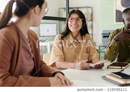 Smiling Woman Leading Meeting in Modern Office Smiling Woman Leading Meeting in Modern Office 118590211