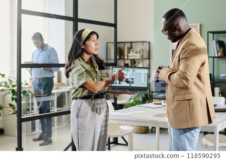 Discussing Business Plans in Modern Office Setting Discussing Business Plans in Modern Office Setting 118590295