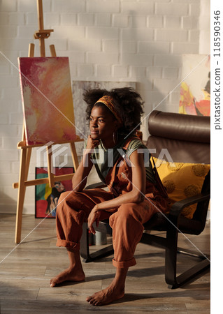 Contemplating Young Artist Sitting in Bright Studio 118590346