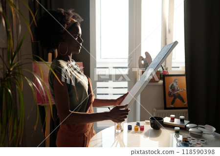 Creating Art in Sunlit Studio with Paints and Canvas 118590398