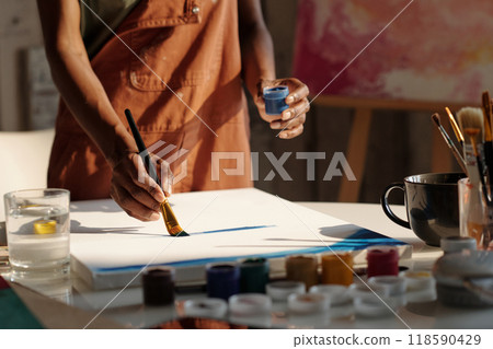 Creating Art with Paints in Well-Lit Studio 118590429