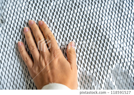 Hand on texture of corrugated white paper for safe transportation, in which the goods brought by the courier delivery service are wrapped, environmental packaging concept 118591527