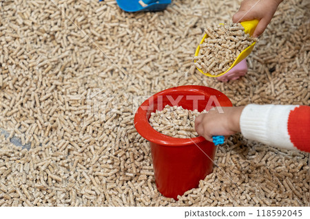 modern children's sandbox with toys. filler form wooden small wood pellets modern children's sandbox with toys. filler form wooden small wood pellets 118592045