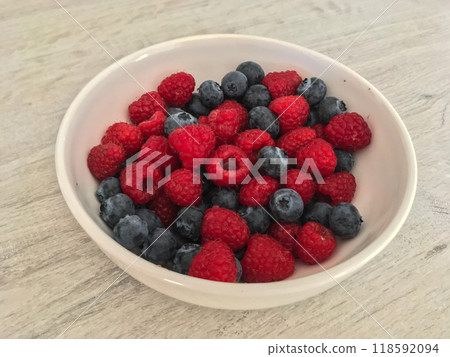 Close-up tasty ripe fresh summer berries - raspberry and blueberry 118592094