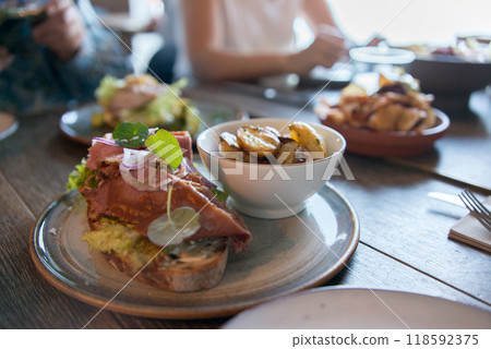 Group of people having dinner in a nordic restaurant. Unrecognizable people. 118592375
