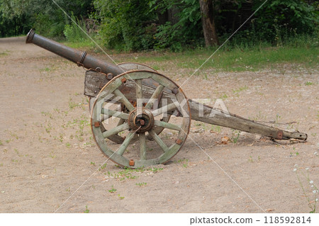 Old wooden cannon. Rusty metal cannons on a wooden base. 118592814