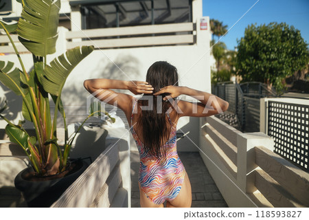 A vibrant swimmer joyfully preparing for an exciting and sunny summer day ahead of them 118593827
