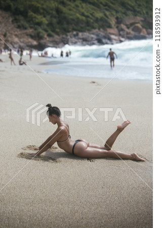 A Beautiful and Relaxing Day at the Beach Enjoying Sunbathing, Waves, and Natures Beauty 118593912