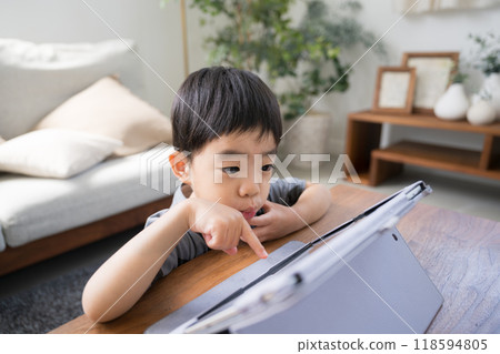 Children studying and playing games on a tablet tapping and smiling 118594805