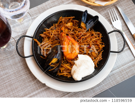 Spanish seafood fideua, noodle paella with aioli Spanish seafood fideua, noodle paella with aioli 118596559