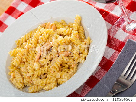 Appetizing pasta with salmon and spices with cream sauce 118596565