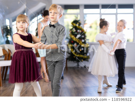 Tween boy and girl performing waltz during Christmas event at school Tween boy and girl performing waltz during Christmas event at school 118596922