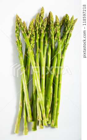 Raw fresh green asparagus isolated on a white background Raw fresh green asparagus isolated on a white background 118597218