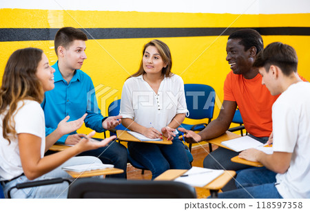 Men and women having fun in speaking club in classroom Men and women having fun in speaking club in classroom 118597358