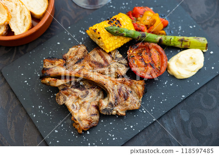 Fried lamb grilled with corn on black background top view close up Fried lamb grilled with corn on black background top view close up 118597485