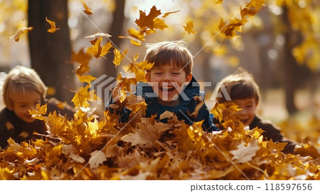 Boy Laughing in Pile of Autumn Leaves Boy Laughing in Pile of Autumn Leaves 118597656
