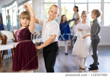 Children dance in pairs at festive matinee 118597980