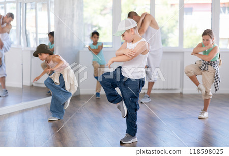 Preteen boy doing hip hop dance during group class Preteen boy doing hip hop dance during group class 118598025