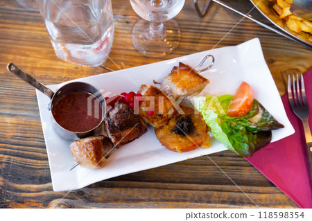 Sliced duck breast on skewer with redcurrant sauce and vegetables 118598354