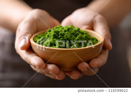 Wolffia or water meal in wooden bowl holding by hand, Edible small aquatic plant high protein Wolffia or water meal in wooden bowl holding by hand, Edible small aquatic plant high protein 118599022