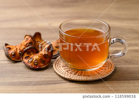 Bael fruit herbal drink in cup glass on wooden background, Healthy drink Bael fruit herbal drink in cup glass on wooden background, Healthy drink 118599038