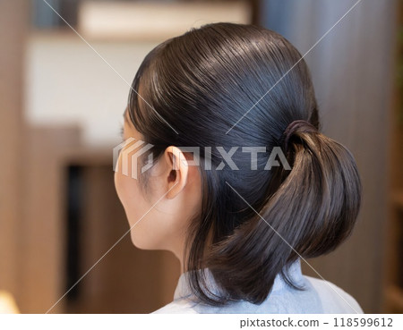 AI-generated image of a woman with her hair tied up AI-generated image of a woman with her hair tied up 118599612