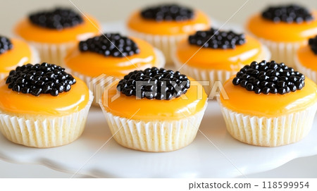 Gourmet delicacy: mini vanilla cupcakes with mango glaze and black caviar 118599954