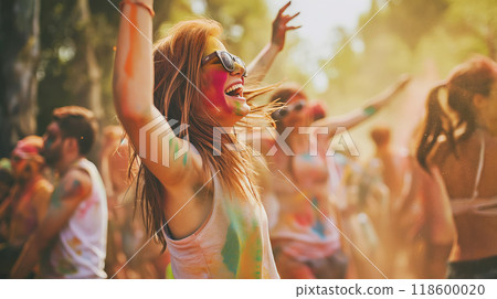 Happy young woman having fun and dancing in crowd at Holi festival of colors, summer party or music festival 118600020