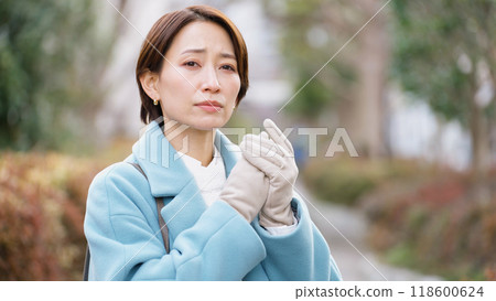 Woman with poor circulation (winter clothes, jacket, coat) Woman with poor circulation (winter clothes, jacket, coat) 118600624