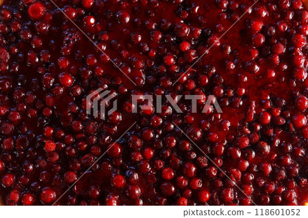 Luscious red cranberries glisten under sunlight, showcasing their vibrant colors during the harvest season in a bountiful orchard 118601052