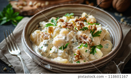 Homemade potato gnocchi in creamy Gorgonzola sauce, topped with toasted walnuts and fresh parsley 118601167