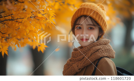 Stylish young woman gazing at autumn leaves Stylish young woman gazing at autumn leaves 118601720