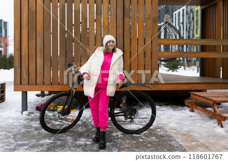 Woman Standing Next to Bike in Snow Woman Standing Next to Bike in Snow 118601767