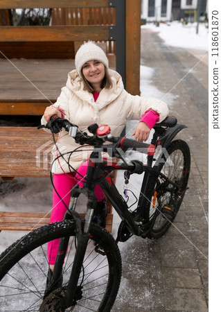 Woman Sitting on Bench Next to Bike Woman Sitting on Bench Next to Bike 118601870