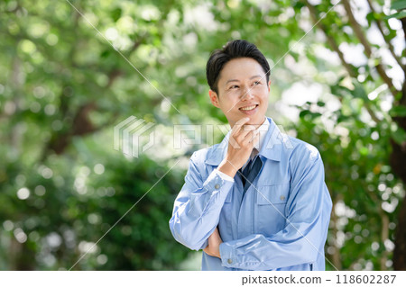 一個穿著工作服、微笑的男人 118602287