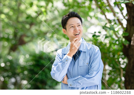 A man wearing work clothes smiling A man wearing work clothes smiling 118602288