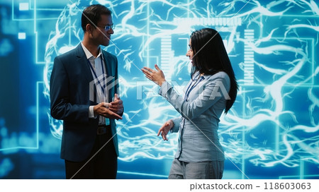 Computer scientists use AI neural networks modeled after human brain to solve complex problems. Startup employees using artificial intelligence to look at data and complete tasks, camera A Computer scientists use AI neural networks modeled after human brain to solve complex problems. Startup employees using artificial intelligence to look at data and complete tasks, camera A 118603063