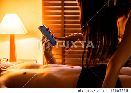 Couples asking for confirmation of sexual consent via smartphone; Man asking for consent from woman; Clear confirmation of intent to engage in sexual activity Couples asking for confirmation of sexual consent via smartphone; Man asking for consent from woman; Clear confirmation of intent to engage in sexual activity 118603286