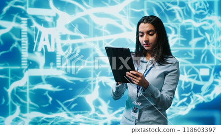 Developer using tablet to implement artificial intelligence parallel processing, breaking up complex computational tasks enabling AI systems to process more input data faster, camera A Developer using tablet to implement artificial intelligence parallel processing, breaking up complex computational tasks enabling AI systems to process more input data faster, camera A 118603397