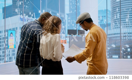 Real estate agent and clients in a high class urban workspace, planning property investment leasing contract, evaluating an office during tour for relocation. Contractor manager. Camera A. Real estate agent and clients in a high class urban workspace, planning property investment leasing contract, evaluating an office during tour for relocation. Contractor manager. Camera A. 118603398