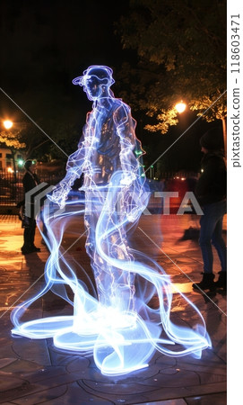 This vibrant urban square hosts a performance art installation with kinetic sculptures and engaging interactive light displays, blending technology with contemporary art, unusualness explosion 118603471