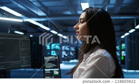 Computer scientist in data center installing software on computer, troubleshooting issues, handheld camera shot. Close up of IT expert in server hub establishing performance benchmarks, camera B Computer scientist in data center installing software on computer, troubleshooting issues, handheld camera shot. Close up of IT expert in server hub establishing performance benchmarks, camera B 118603622