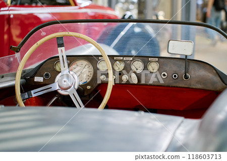Classic retro car interior showing steering wheel, dashboard and gauges Classic retro car interior showing steering wheel, dashboard and gauges 118603713