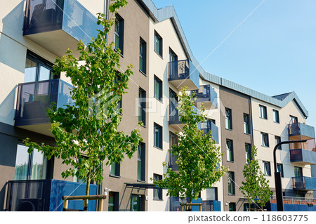 Modern apartment building with balconies and green trees on sunny day. Residential complex in Wroclaw, Poland. Mortgage in real estate 118603775