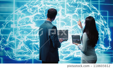 Team of admins using tablet and laptop to maintenance artificial intelligence neural networks. Teamworking IT staff members using AI system aiding in processing and transmitting information, camera B 118603812